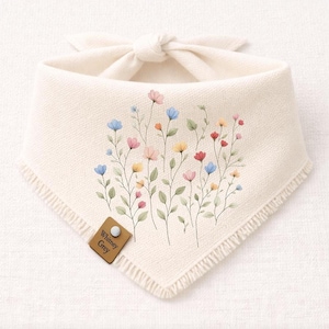 A white fabric bandana with a floral design featuring colorful flowers and leaves.