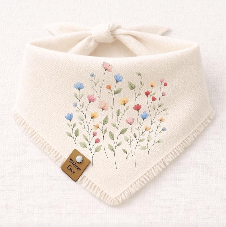 A white fabric bandana with a floral design featuring colorful flowers and leaves.