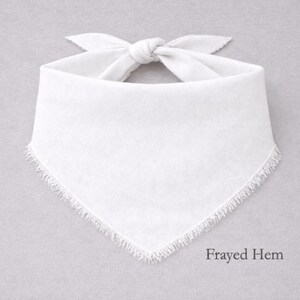 A white bandana with fringed edges is displayed against a gray background.