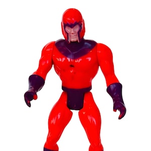 May include: A red and purple plastic action figure of Magneto, a Marvel Comics superhero. The figure is posed with its arms outstretched and its legs slightly apart.