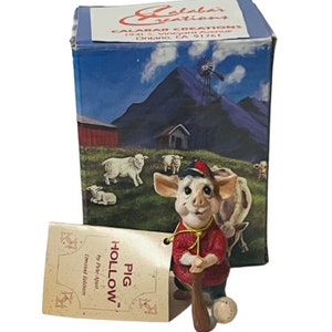 May include: A red and white pig figurine holding a baseball bat and ball. The figurine is part of a limited edition collection called "Pig Hollow" by the artist,  "Pine Apart".