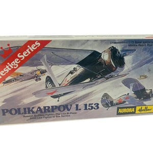 May include: A model kit box for a 1/72 scale Polikarpov I. 153 Russian bi-plane fighter. The box features a colorful illustration of the plane in flight, along with the text "Prestige Series" and "Aurora Heller".