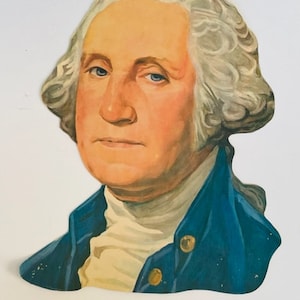 May include: A vintage paper cutout of George Washington, the first president of the United States. He is depicted with a white wig, a blue jacket, and a white shirt.