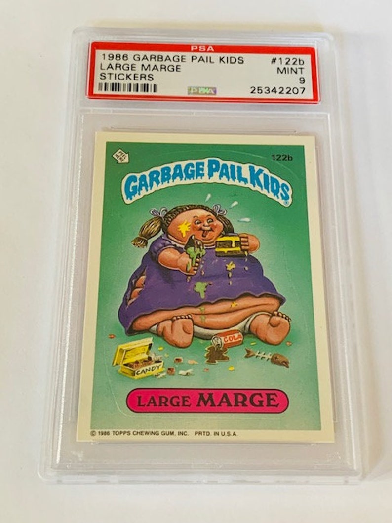 Puede incluir: Una tarjeta de intercambio de Garbage Pail Kids con un personaje de dibujos animados llamado Large Marge. La tarjeta es de la serie de 1986 y est&aacute; calificada con un 9 de 10. La tarjeta est&aacute; en una caja de pl&aacute;stico protectora.