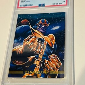 May include: A graded trading card featuring Thanos, a Marvel Comics character, in a purple and gold costume. The card is from the 1993 Marvel Masterpcs series and is graded Mint 9 by PSA. The card number is #35.