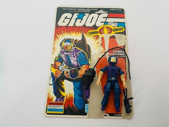 A shopper looks at a wall of G.I. Joe action figures and