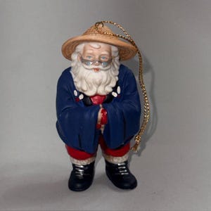 May include: A trio of ceramic mugs with a speckled, matte finish in cream, light grey, and dark grey. Each mug features a simple, minimalist design, ideal for tea or coffee.