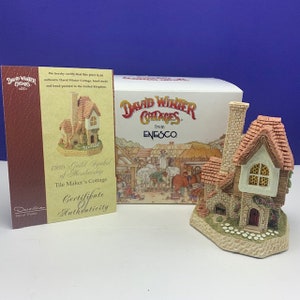 May include: A hand-painted ceramic cottage figurine with a red tiled roof and stone walls. The image includes a certificate of authenticity and a box from the David Winter Cottages collection.