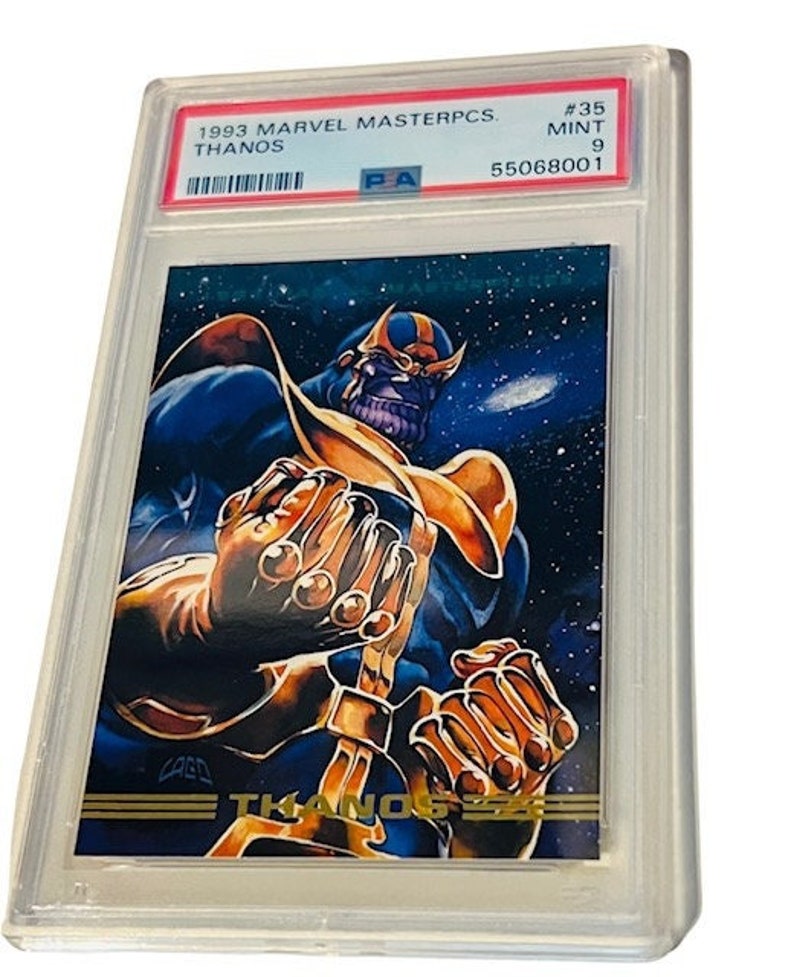 May include: A graded Marvel Masterpcs trading card featuring Thanos, a purple-skinned supervillain from the Marvel Universe. The card is numbered #35 and graded as Mint 9. The card shows Thanos with his signature Infinity Gauntlet, a powerful weapon that allows him to control the Infinity Stones.