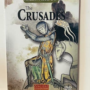 May include: DVD cover for a documentary about the Crusades. The cover features an illustration of a medieval knight kneeling on one knee, holding a sword and a shield with a cross. The knight is wearing chainmail armor and a yellow tunic. The DVD cover is titled "The Crusades" and is part of the "Ancient Civilizations" series.