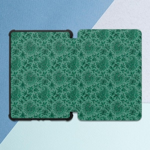 May include: A green paisley pattern covers a tablet case and a separate cover. The design features intricate floral and teardrop-shaped motifs in varying shades of green. The tablet case has a black border, and the background is a light green.
