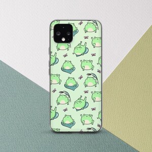 May include: A green phone case with a repeating pattern of green frogs on a light green background. The frogs are in various poses, some are sitting, some are jumping, and some are swimming. There are also small pink butterflies scattered throughout the pattern.