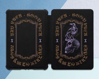 May include: A black leather-bound journal with a gold-colored design. The front cover features a skull with a raven perched on top. The text "LACK - GOOD - LACK - CAPT" is written around the skull and raven.