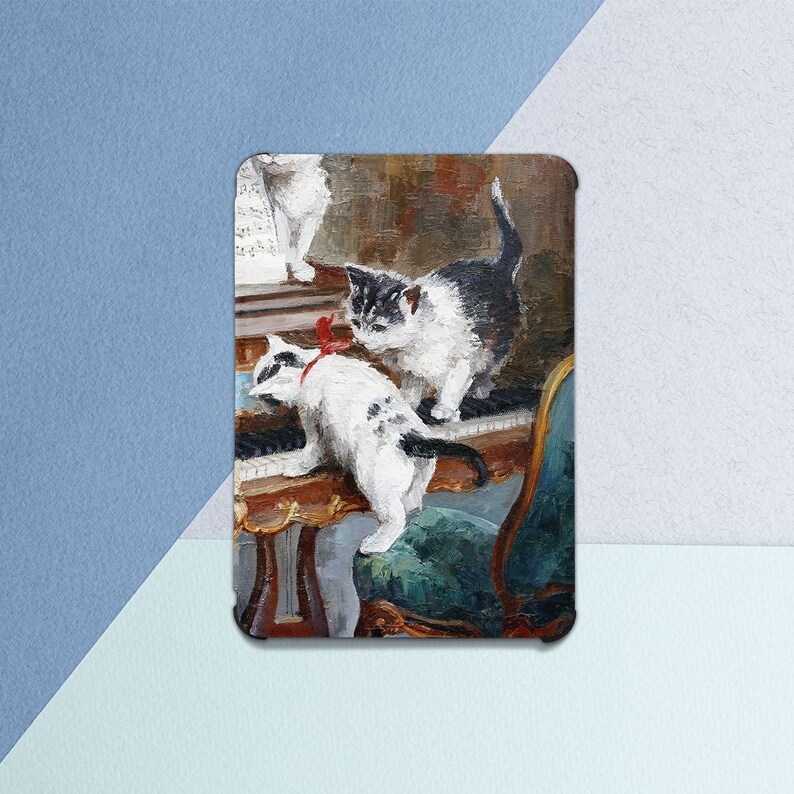 May include: A rectangular print featuring an oil painting of three kittens playing on and around a piano. The kittens are black and white, with one wearing a red bow. The piano is ornate, with a green chair visible. The background is a warm, muted color palette.