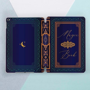 May include: A blue and gold iPad case with a decorative design that looks like a vintage book cover. The cover says "Magic Book" in a cursive font.