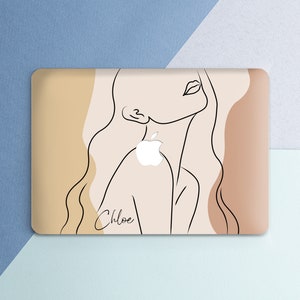 May include: A laptop skin with a minimalist line drawing of a woman's face and the name "Chloe" in cursive. The background is a light brown with abstract shapes.