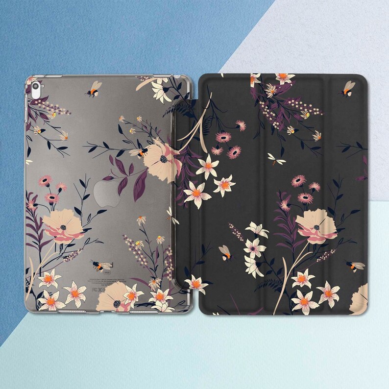 May include: A floral patterned tablet case with a clear back and a black front. The case has a floral design with bees and leaves.
