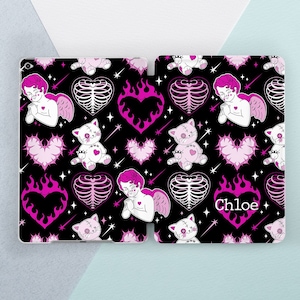 May include: Black iPad case with a pink and white pattern featuring cherubs, cats, hearts, and flames. The text "Chloe" is printed in pink on the case.