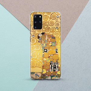 May include: A phone case featuring Gustav Klimt's "The Kiss" artwork. The case has a clear border and a gold, yellow, and multi-colored design. The artwork depicts two figures embracing, set against a background of gold swirls.