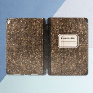 May include: A brown leather-bound notebook with a label that says "Composition".