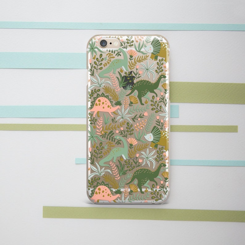 May include: A clear phone case with a colorful pattern of dinosaurs and plants. The dinosaurs are green, pink, and yellow. The plants are green and brown.