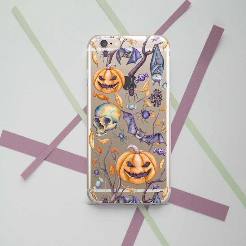 May include: A clear phone case with a Halloween-themed design. The case features a repeating pattern of orange pumpkins with jack-o'-lantern faces, bats, spiders, and skulls. The design is done in a watercolor style.