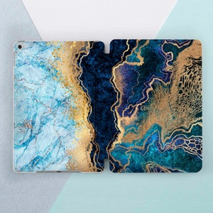 May include: An iPad case with a blue and gold marble pattern. The case is made of two pieces that snap together. The left side of the case has a light blue background with gold veins and a dark blue border. The right side of the case has a dark blue background with gold veins and a light blue border.