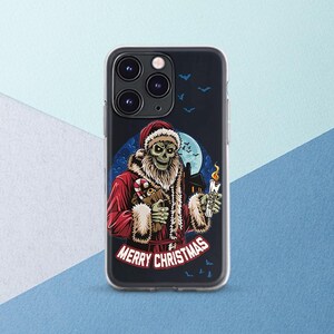 May include: A clear phone case with a design of a skeleton dressed as Santa Claus holding a candy cane and a lit candle. The design is on a black background with a full moon and bats. The text "Merry Christmas" is at the bottom of the design.