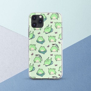 May include: A clear phone case with a green background and a repeating pattern of green frogs. The frogs are in various poses, some are sitting, some are jumping, and some are swimming. There are also small pink flowers scattered throughout the pattern.