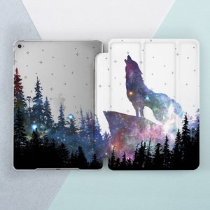 May include: A white iPad case with a galaxy print and a silhouette of a wolf howling at the moon. The case has a starry night sky background with a forest silhouette.