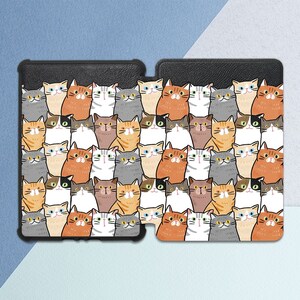 May include: A black phone case with a pattern of colorful cats. The cats are all different colors and have different expressions.