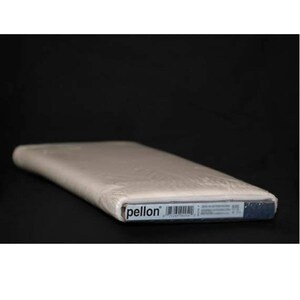 May include: A roll of Pellon fabric, wrapped in clear plastic, against a black background. The fabric is a light beige color. The Pellon logo is visible on the label.