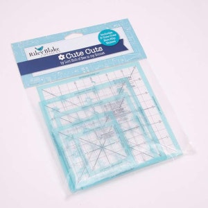 May include: A package of five blue plastic quilting rulers called "Cute Cuts" by Lori Holt of Bee in my Bonnet. The rulers are non-slip and come in various sizes.