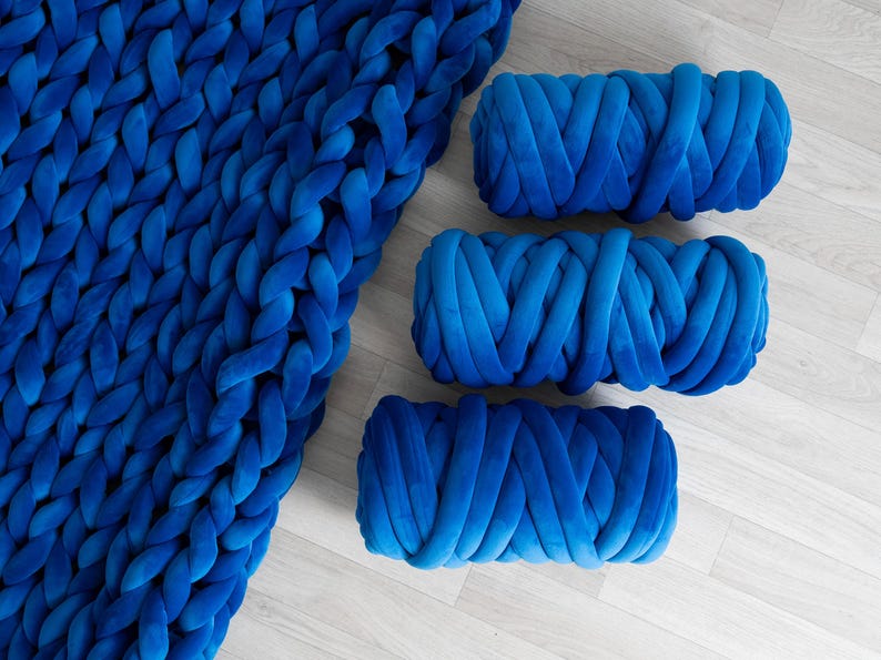A soft, handmade chunky knit blanket crafted from plush velvet yarn. This giant knit throw blanket adds warmth and texture to any living space, perfect for home décor, bedding, or gifting.