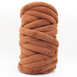 A collection of soft, chunky velvet yarn in a variety of beautiful colors, neatly arranged to showcase the available options for a handmade chunky knit blanket. The vibrant and neutral shades allow for a perfect match to any home décor style.