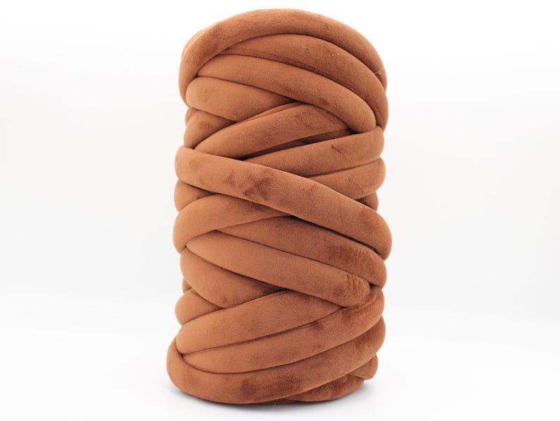 A collection of soft, chunky velvet yarn in a variety of beautiful colors, neatly arranged to showcase the available options for a handmade chunky knit blanket. The vibrant and neutral shades allow for a perfect match to any home décor style.