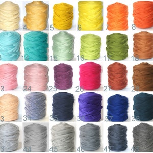 May include: A collection of 50 spools of colorful yarn, each in a different shade. Colors range from white, cream, and yellow to orange, red, and burgundy. Other colors include teal, green, purple, pink, and gray.