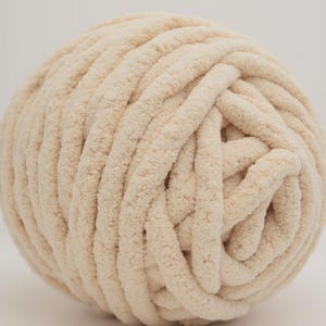 Cream color chunky chenille yarn in white background