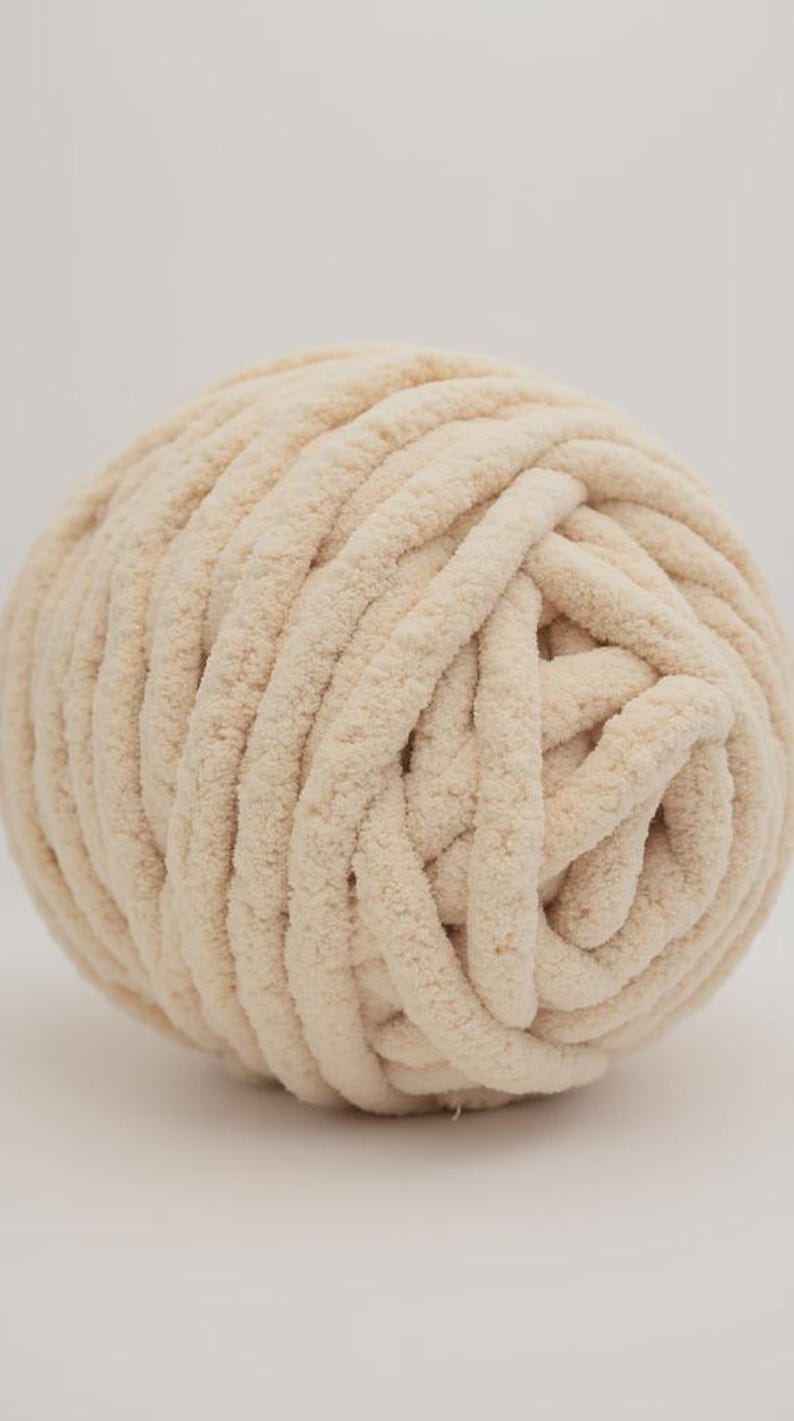 Cream color chunky chenille yarn in white background