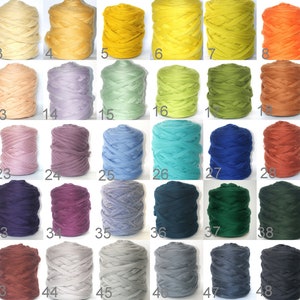 May include: Fifty skeins of yarn in various colors, including white, beige, light blue, green, yellow, orange, red, pink, purple, brown, gray, and black. Each skein is labeled with a number from 1 to 50.