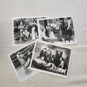 May include: Four black and white photographs of scenes from the Wizard of Oz movie. The first photo shows Dorothy, the Scarecrow, the Tin Man, and the Cowardly Lion walking down a path. The second photo shows Dorothy, the Scarecrow, and the Tin Man standing in a room. The third photo shows Dorothy, the Scarecrow, and the Tin Man standing in a room. The fourth photo shows Dorothy, the Scarecrow, and the Tin Man standing in a room.