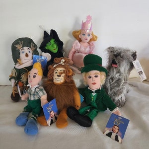 May include: A set of plush toys from the Wizard of Oz movie. The set includes Dorothy, the Scarecrow, the Tin Man, the Cowardly Lion, the Wicked Witch of the West, and Toto the dog. The toys are all in their iconic costumes and are made of soft, cuddly fabric.