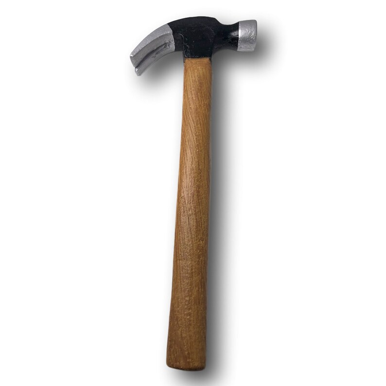 May include: A black and silver hammer with a wooden handle.