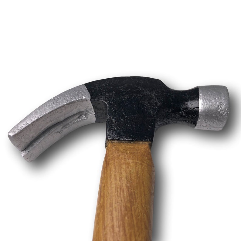 May include: A black and silver claw hammer with a wooden handle.