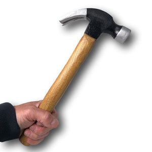 May include: A person holding a black and silver hammer with a wooden handle.