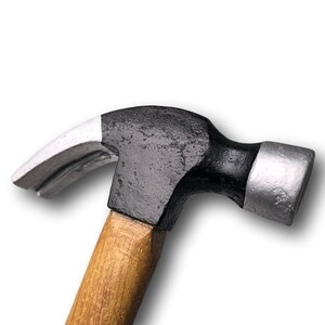 May include: A black and silver claw hammer with a wooden handle.