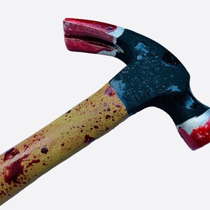 May include: A black and red hammer with a wooden handle stained with red splatter paint. The hammer has a claw on the back.