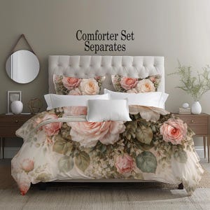 May include: A floral comforter set with large pink and cream roses and green leaves. The set includes a comforter, pillowcases, and decorative pillows. The text "Comforter Set Separates" is displayed at the top.