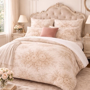 May include: A bedroom scene featuring a bed with a tufted headboard and floral bedding in cream and beige tones. A pink throw pillow and a matching ottoman add color. A chandelier and bedside lamps complete the elegant decor.