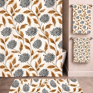 May include: A bathroom set featuring a shower curtain, two towels, and a bath mat. The set has a cream background with a repeating pattern of black berry clusters and brown leaves on winding stems. The items are designed to coordinate.